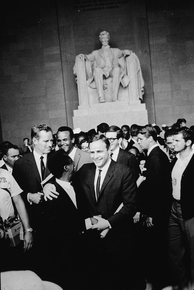 Baldwin and Brando embrace at the Lincoln Memorial during the March on Washington, August 1963, as Charlton Heston and Harry Belafonte look on. (<a href="http://www.gettyimages.com/license/51028235">Hulton Archive</a>/Getty Images)